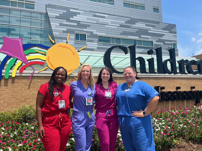 group of four residents standing in front of Children's of Mississippi